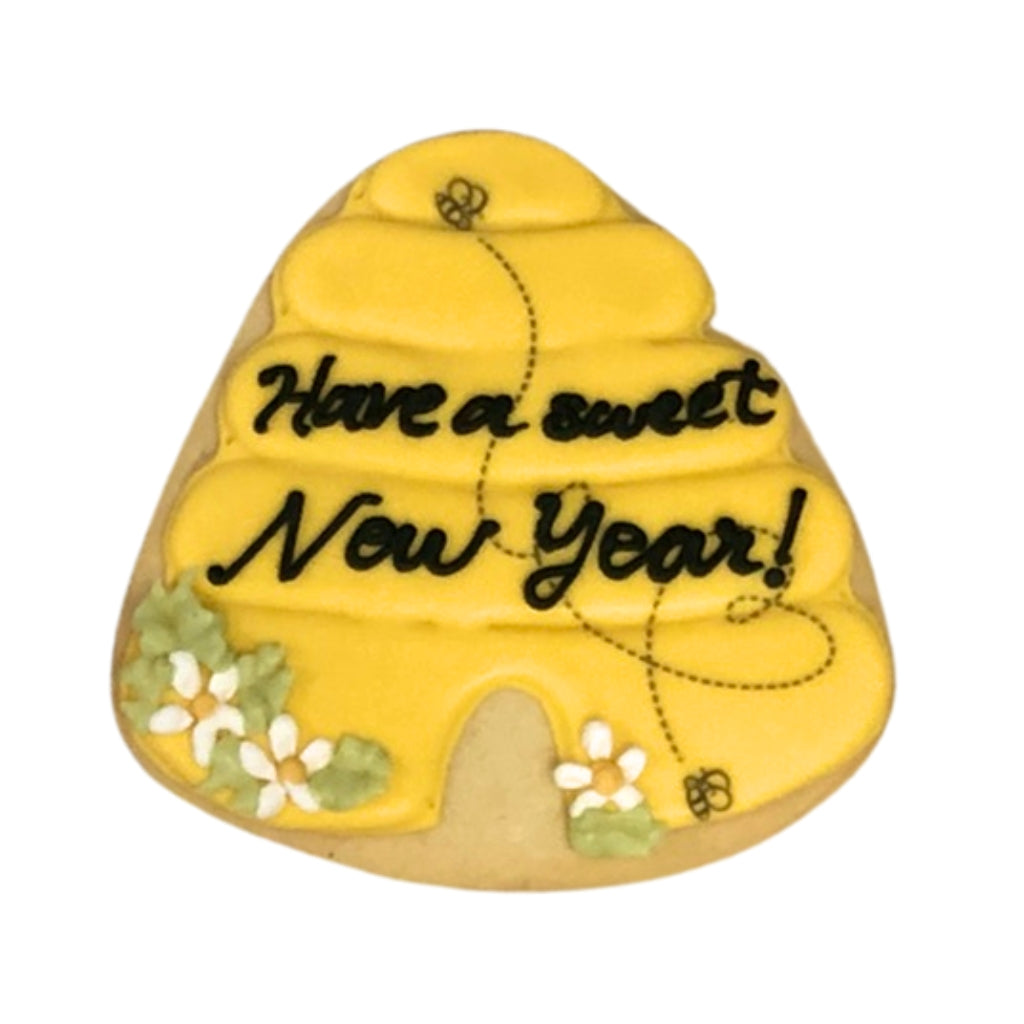 Jewish High Holidays beehive cookie with floral icing.