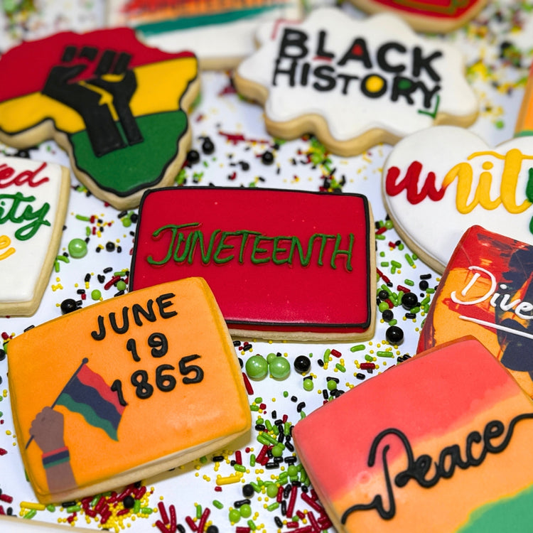 Assorted Juneteenth cookies with colorful icing and text.