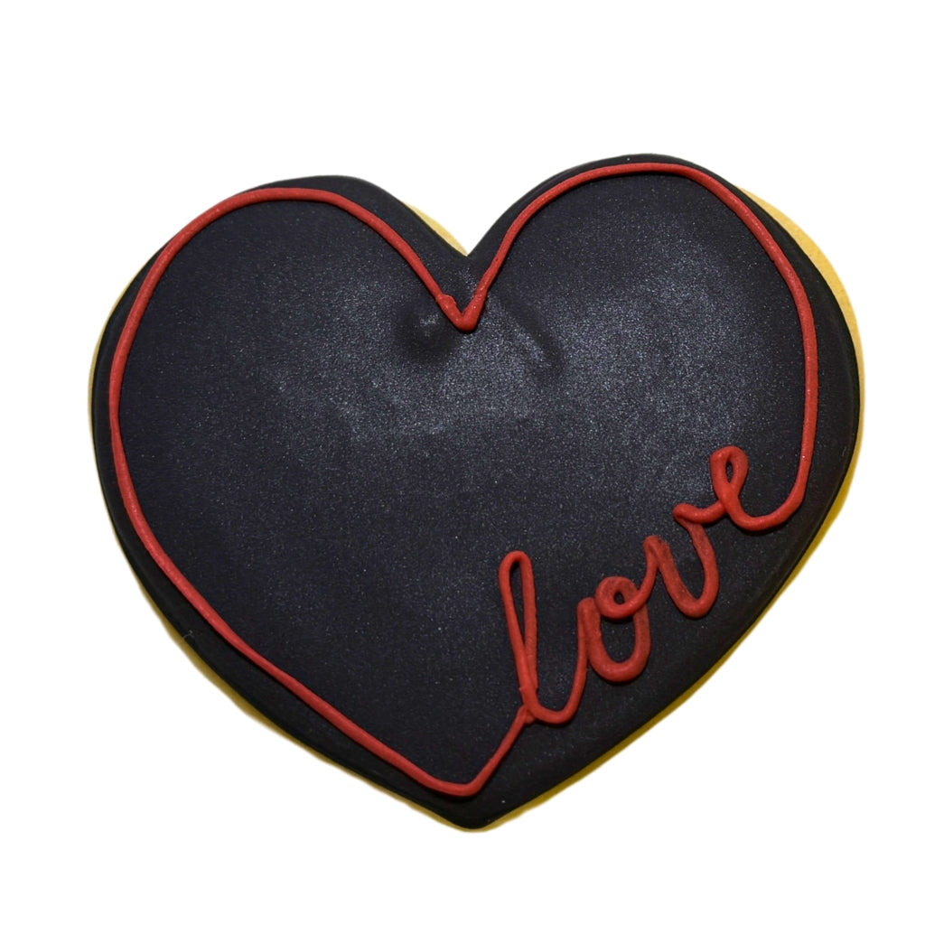 Juneteenth heart-shaped cookie with black icing and red love text.
