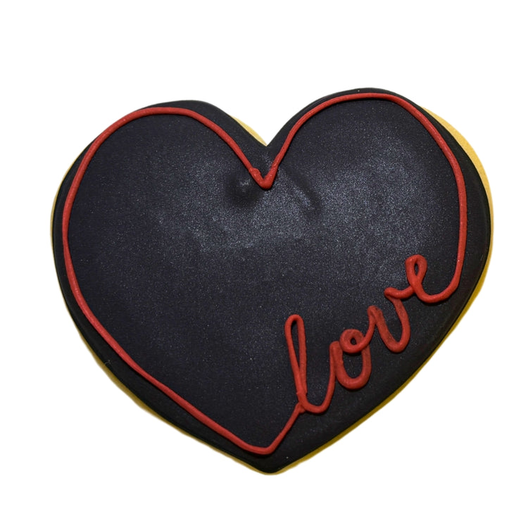 Juneteenth heart-shaped cookie with black icing and red love text.