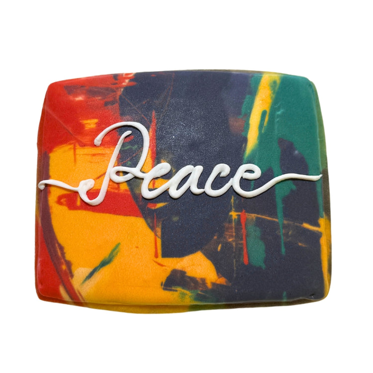 Juneteenth cookie with abstract red, yellow, and green design.