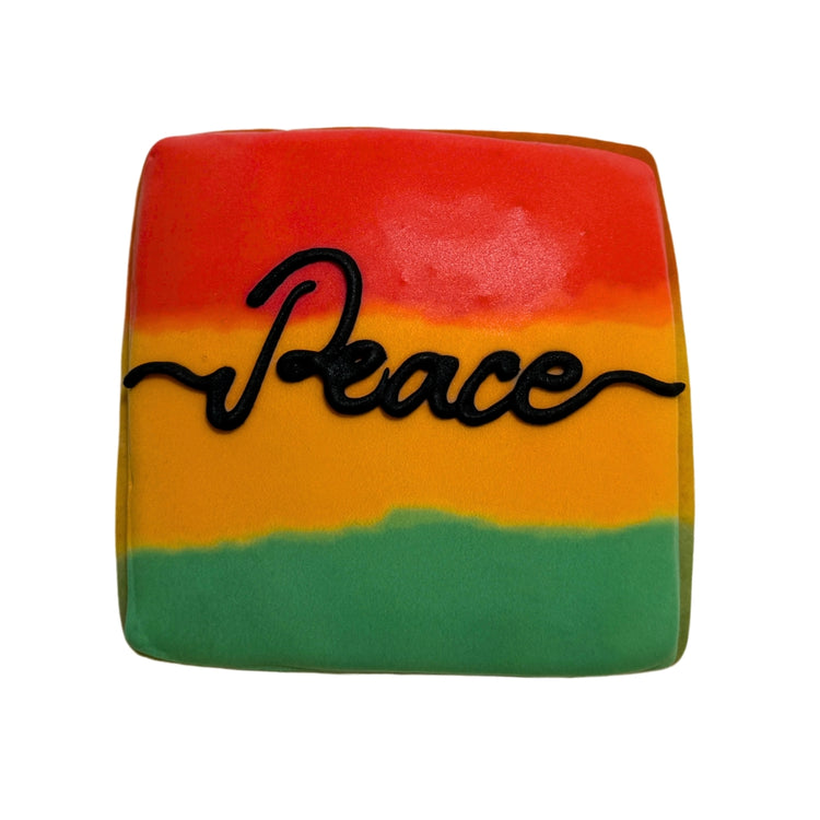 Juneteenth cookie with red, yellow, green icing and Peace text.