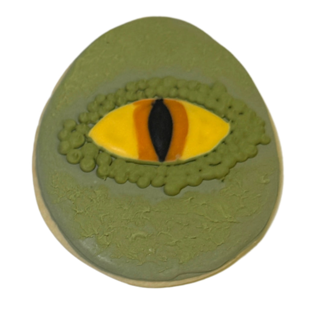 Jurassic Cookie with a green dinosaur eye design