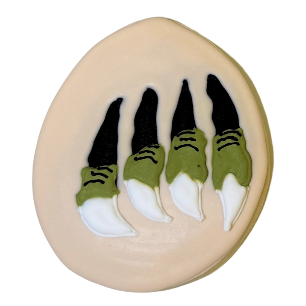 Jurassic Cookie with green and white dinosaur claw icing.