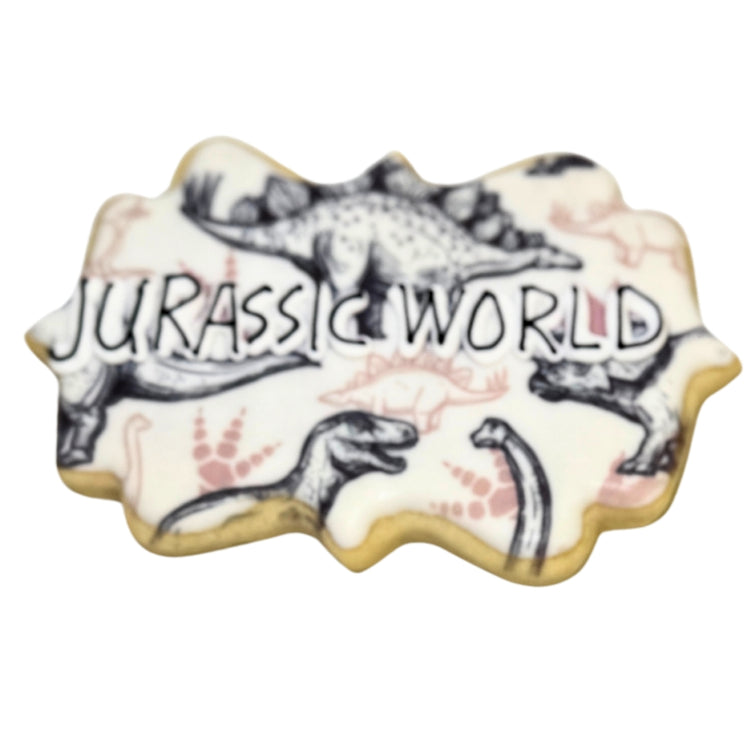 Jurassic World cookie with black and white dinosaur patterns.