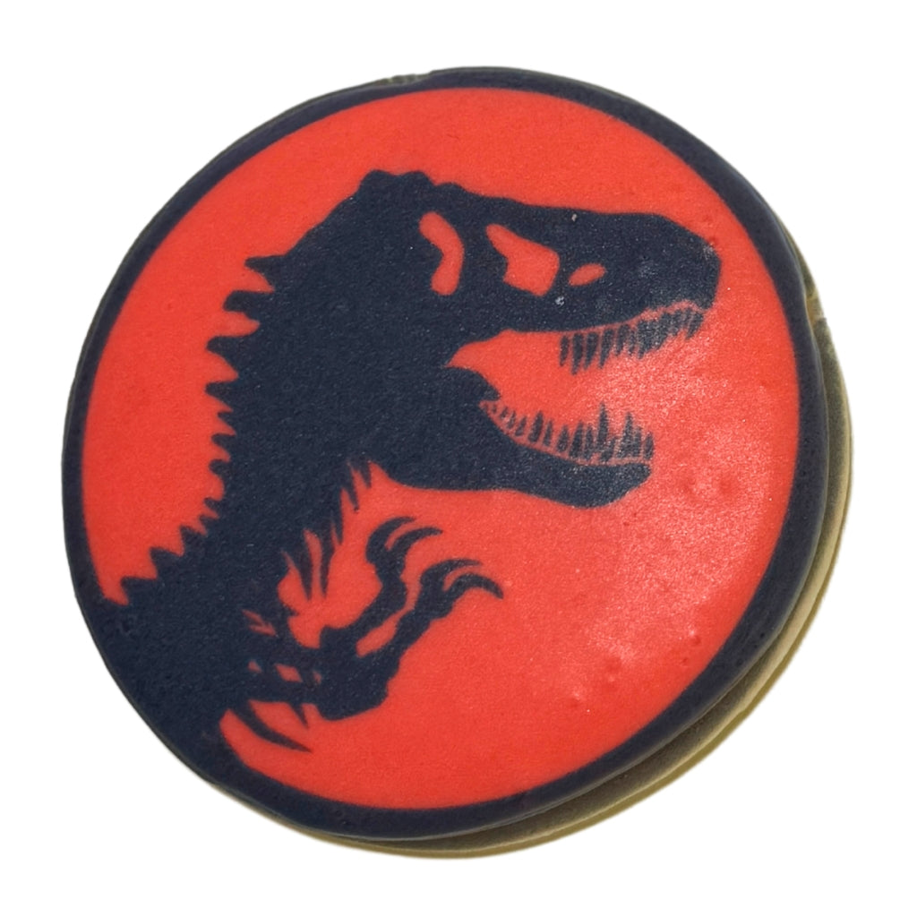 Jurassic cookie with a black dinosaur silhouette on red icing.