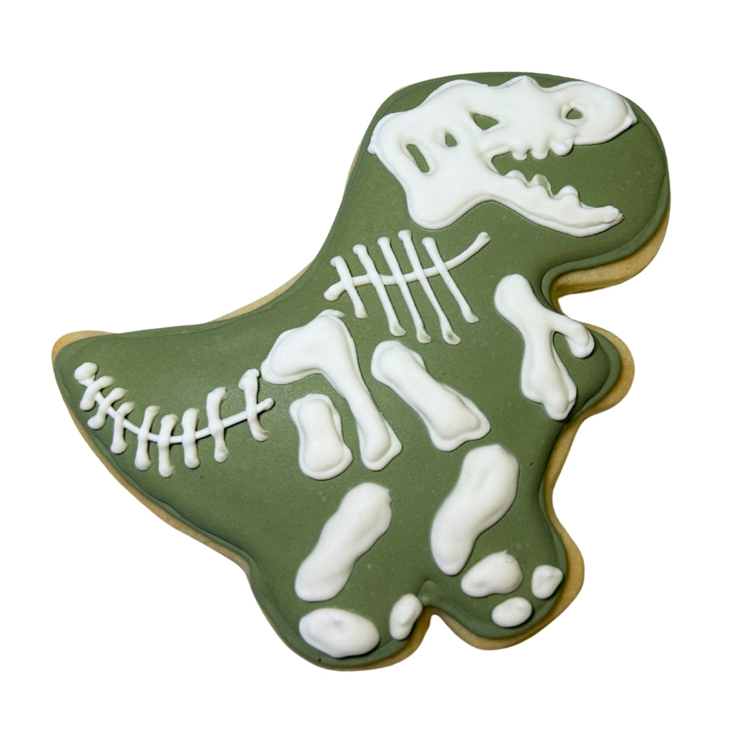 Jurassic Cookie shaped like a T-Rex with white icing skeleton.