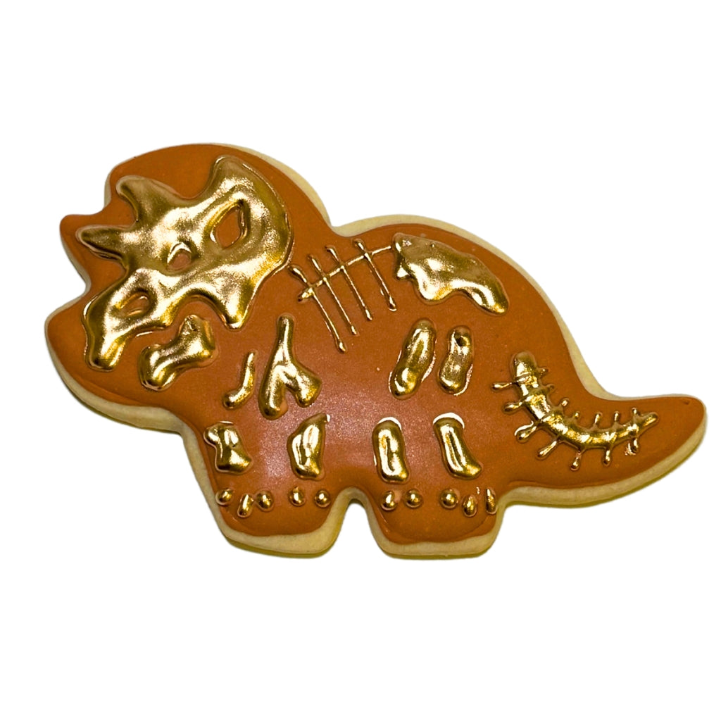 Jurassic Cookie shaped like a triceratops with gold icing.