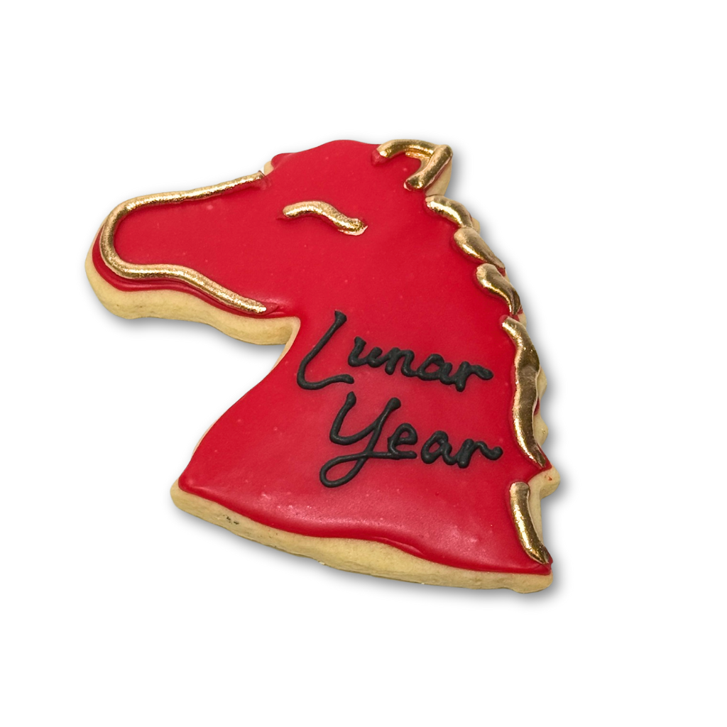 Red horse-shaped Lunar New Year cookie with gold accents.