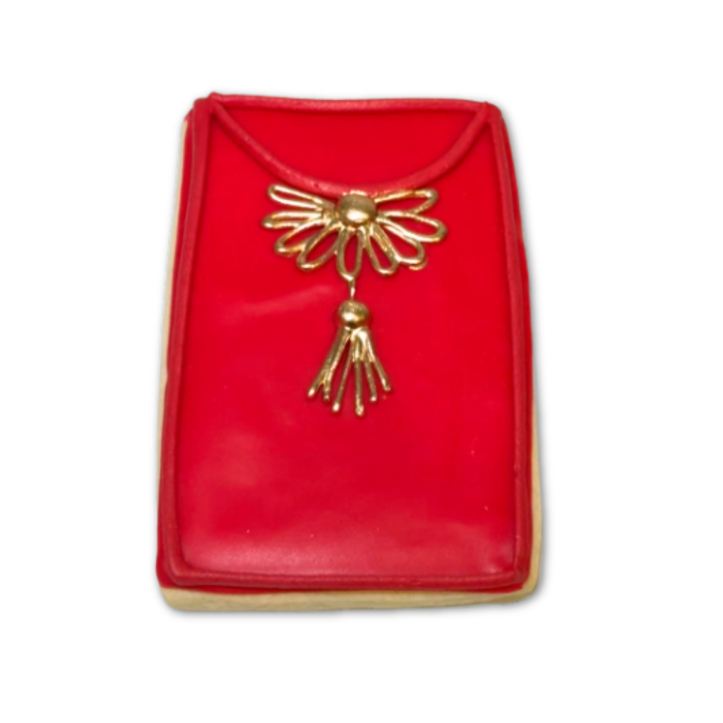 Lunar New Year cookie shaped like a red envelope with gold detail.