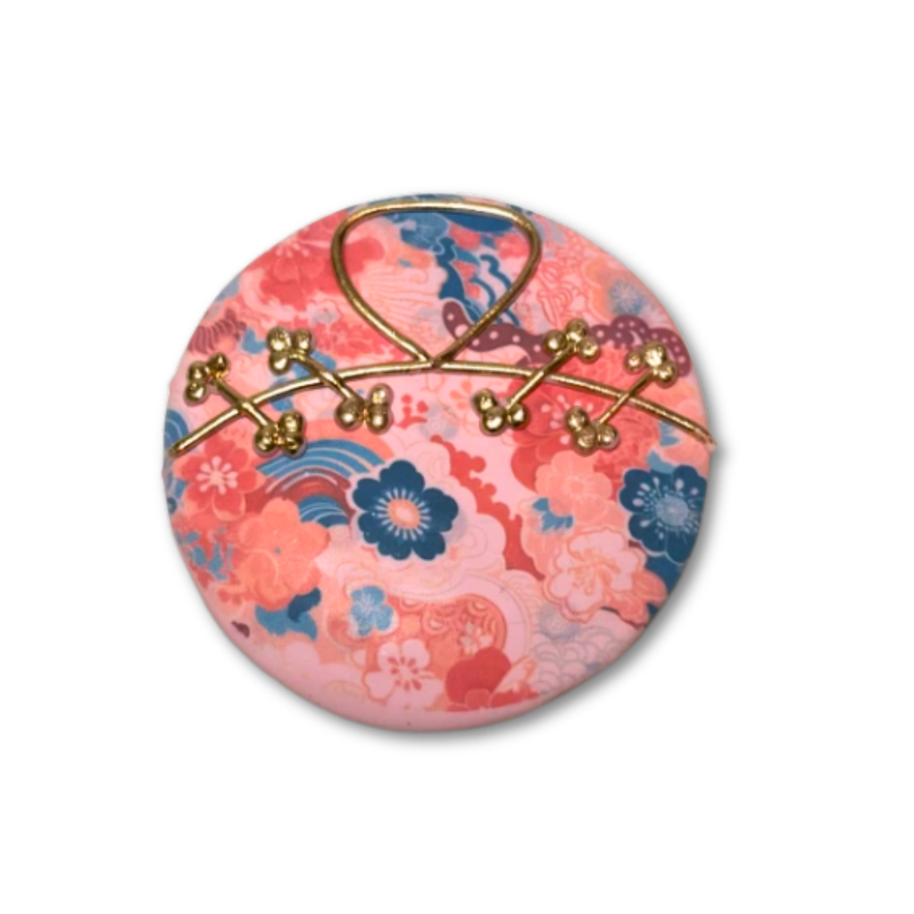 Lunar New Year cookie with pink floral pattern and gold wire.