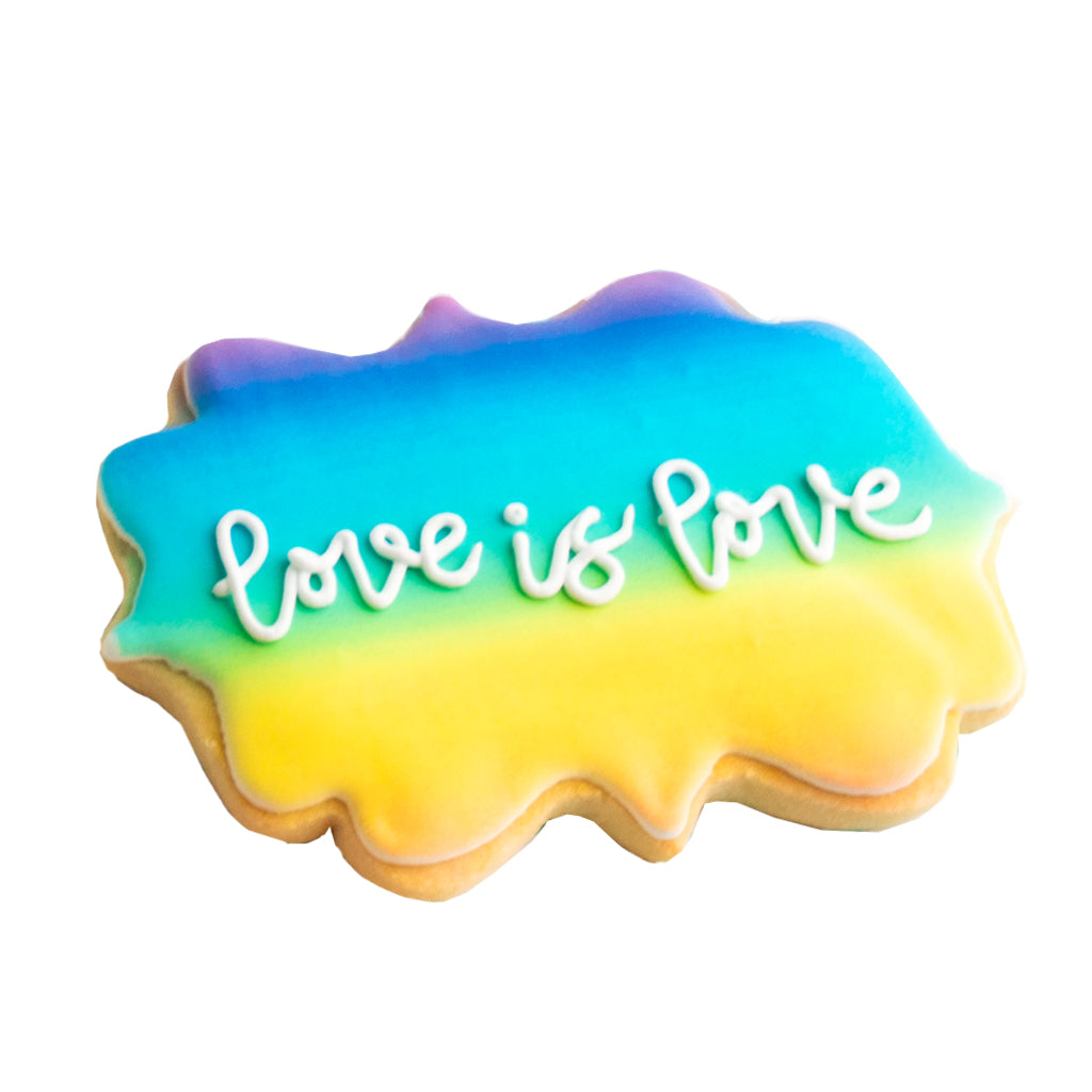 Love is Love cookie with a rainbow gradient icing background.