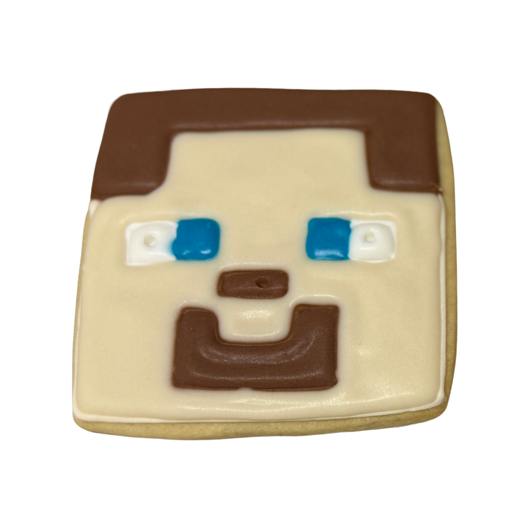 Minecraft Steve cookie with brown and blue icing detail.