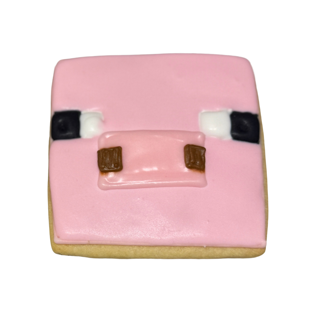 Square Minecraft pig cookie with pink icing face.