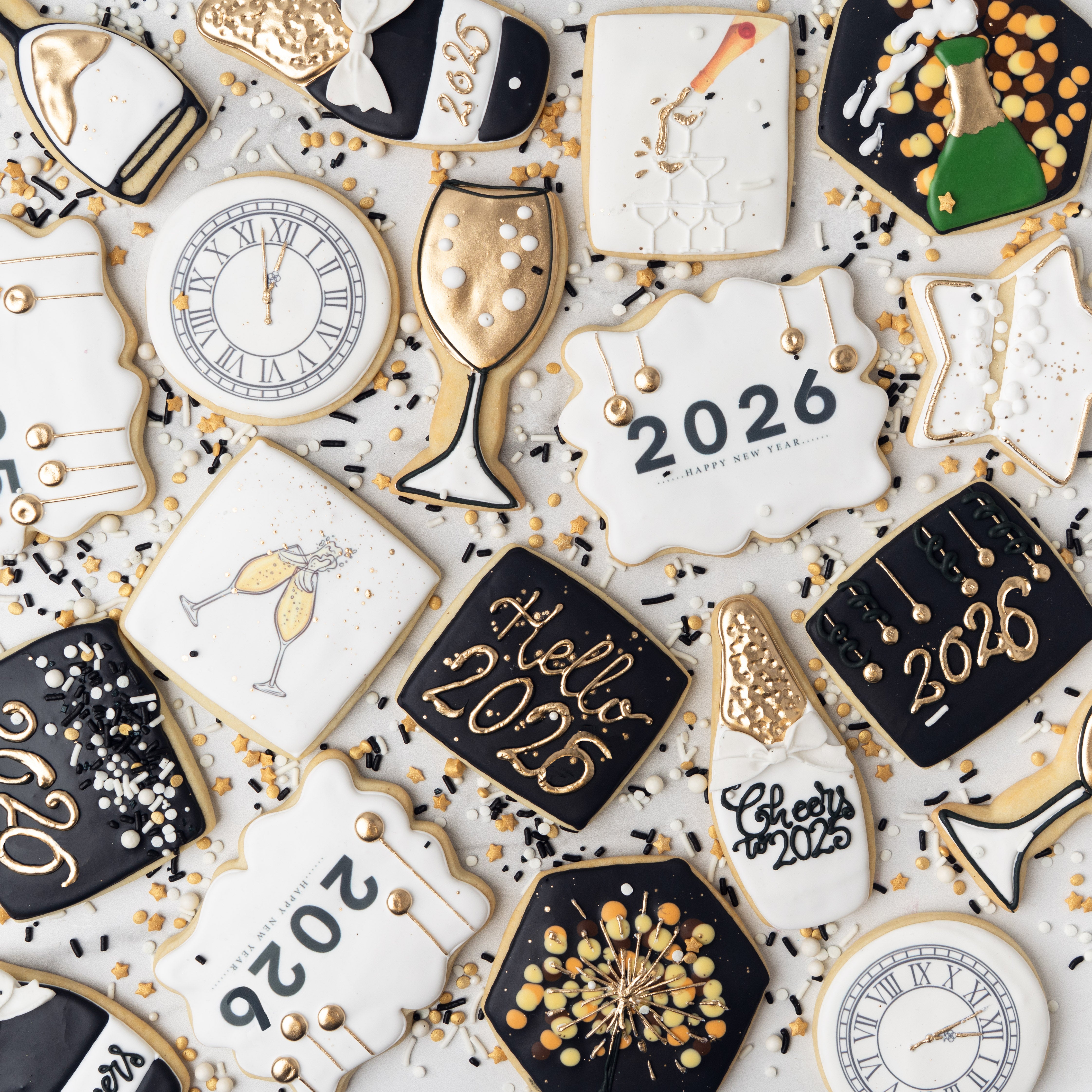 Assorted New Year butter cookies with black, white, and gold icing.