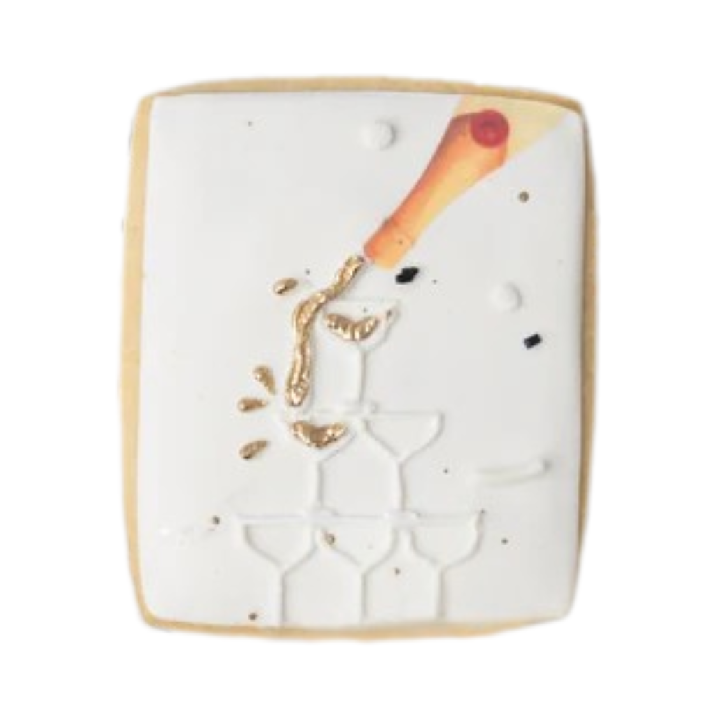 New Year cookie with gold champagne tower icing design