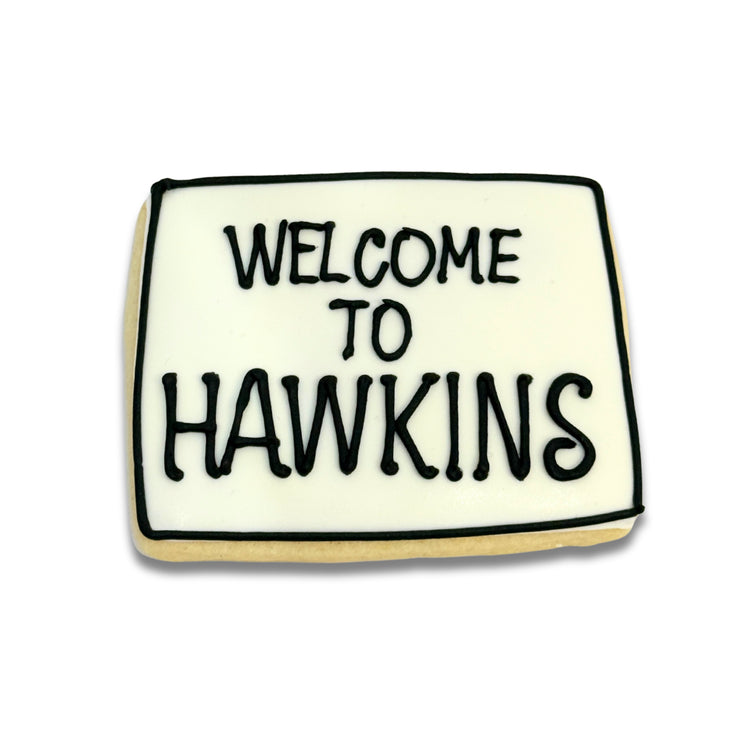 Stranger Cookies rectangular sugar cookie with black lettering.