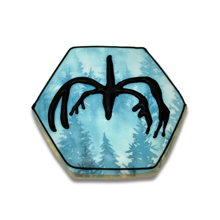 Hexagonal Stranger cookie with a black monster silhouette.