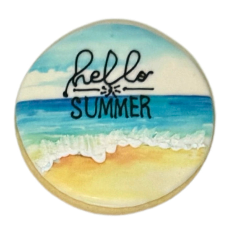 Round Summer cookie with a beach scene and Hello Summer text.
