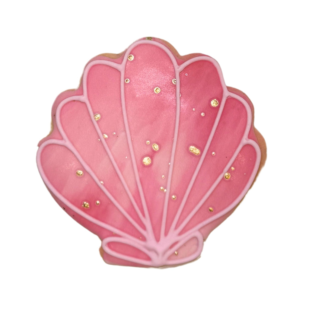 Pink seashell-shaped summer cookie with gold accents