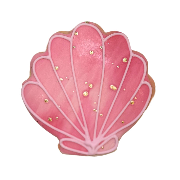 Pink seashell-shaped summer cookie with gold accents