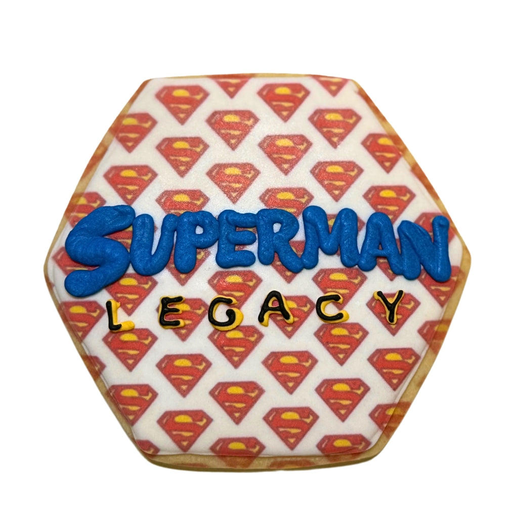Hexagonal Superman Legacy cookie with red logo pattern.