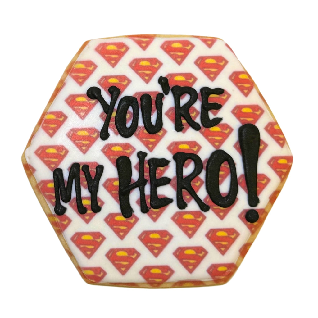 Hexagonal Superman cookie with You're My Hero icing.