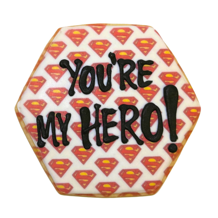 Hexagonal Superman cookie with You're My Hero icing.