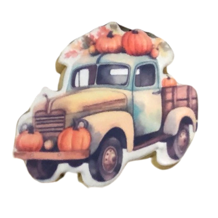 Thanksgiving cookie shaped like a vintage truck with pumpkins.