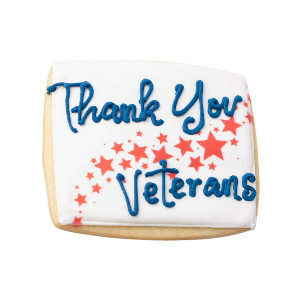 Veterans Day cookie with blue icing and red star accents.
