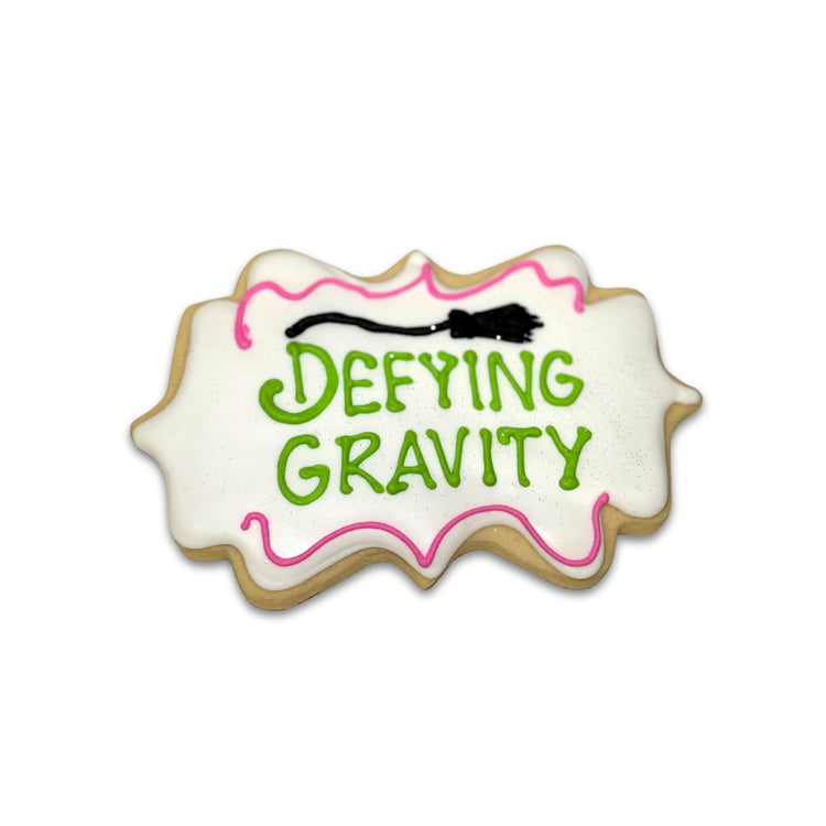 Wickedly Sweet Cookie with Defying Gravity text and broom icon