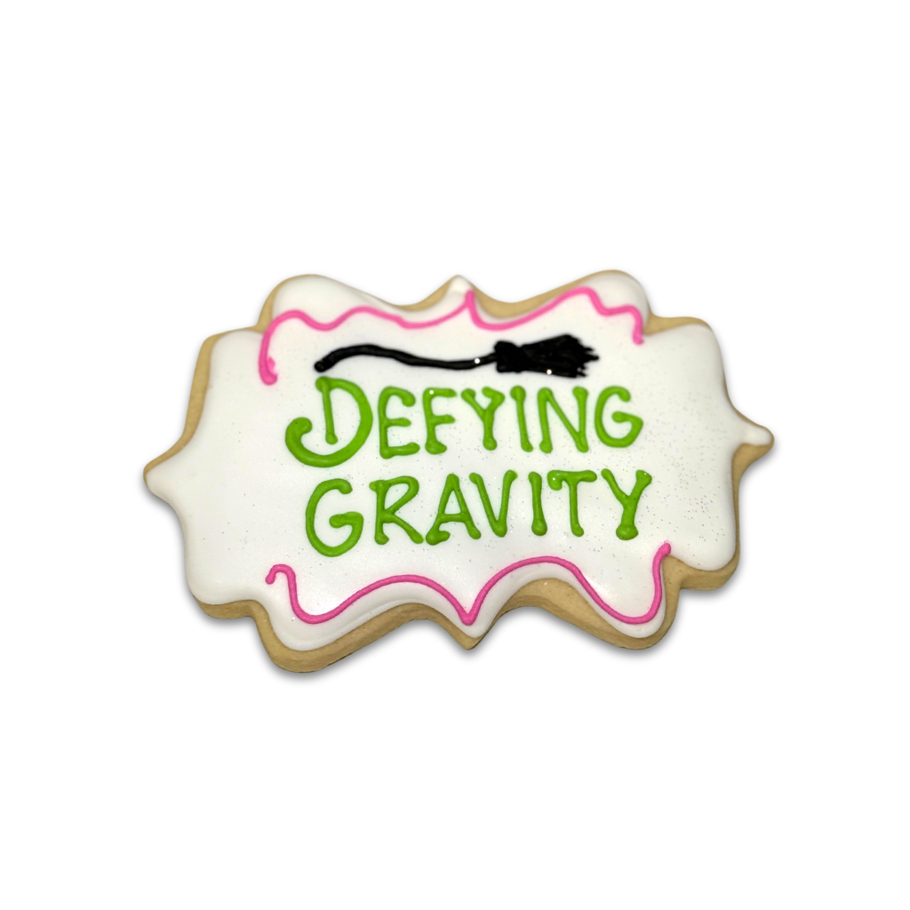 Wickedly Sweet Cookie with Defying Gravity text and broom icon