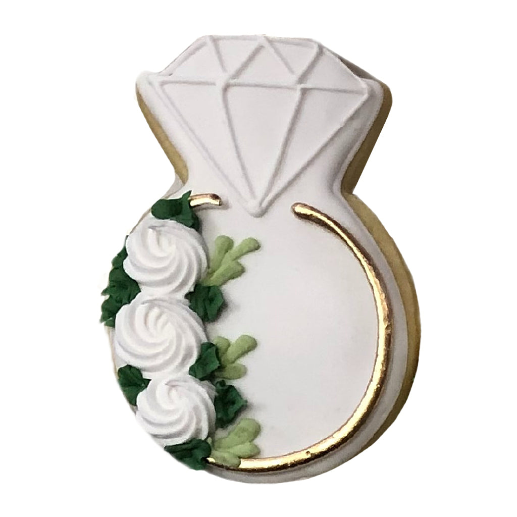 White floral wedding ring cookie decorated with icing.