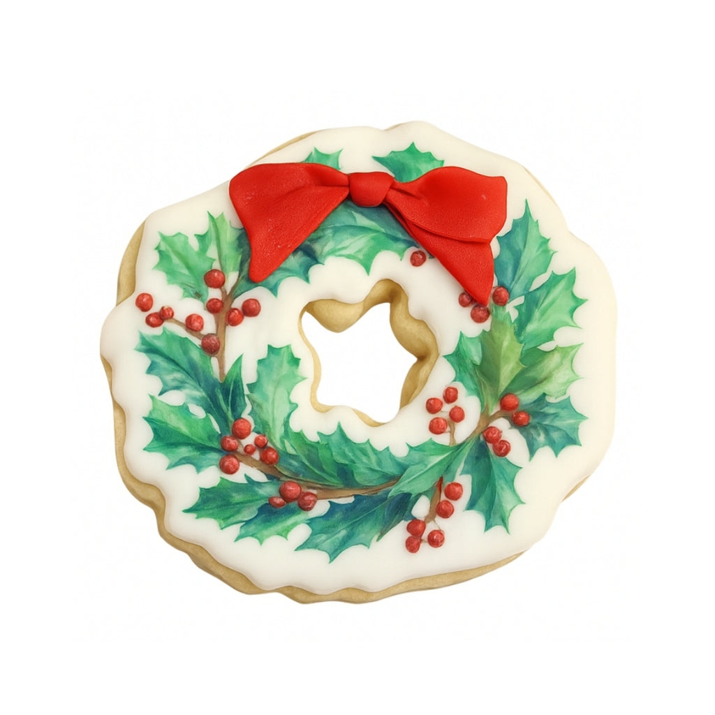 Christmas character cookie shaped like a holly wreath with a red bow.
