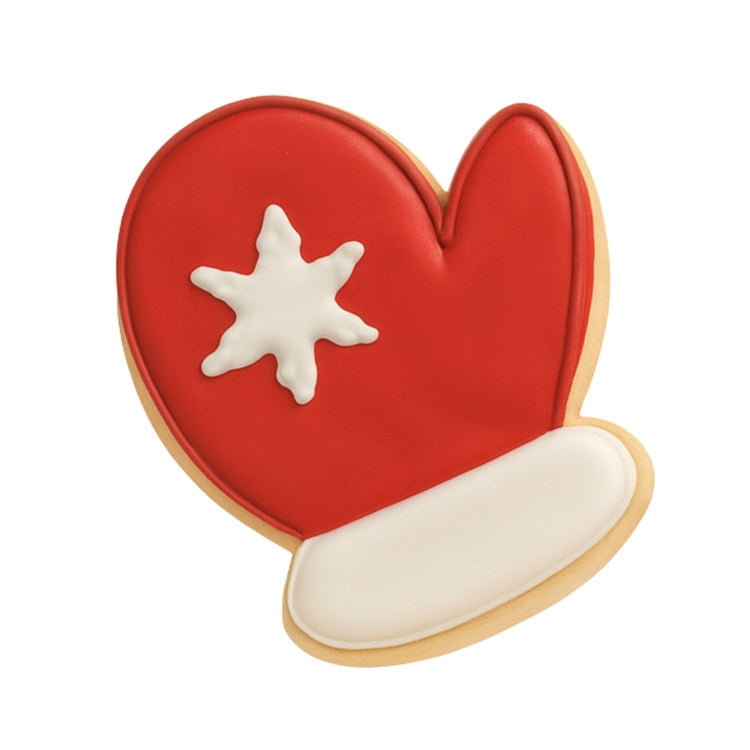 Christmas Couture mitten cookie with red icing and snowflake.
