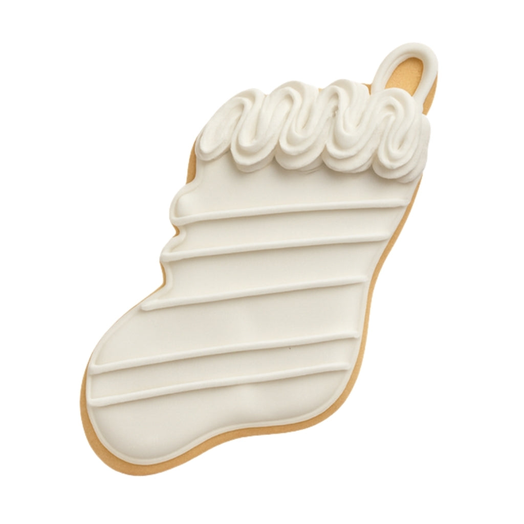 Christmas Couture stocking cookie with white icing.
