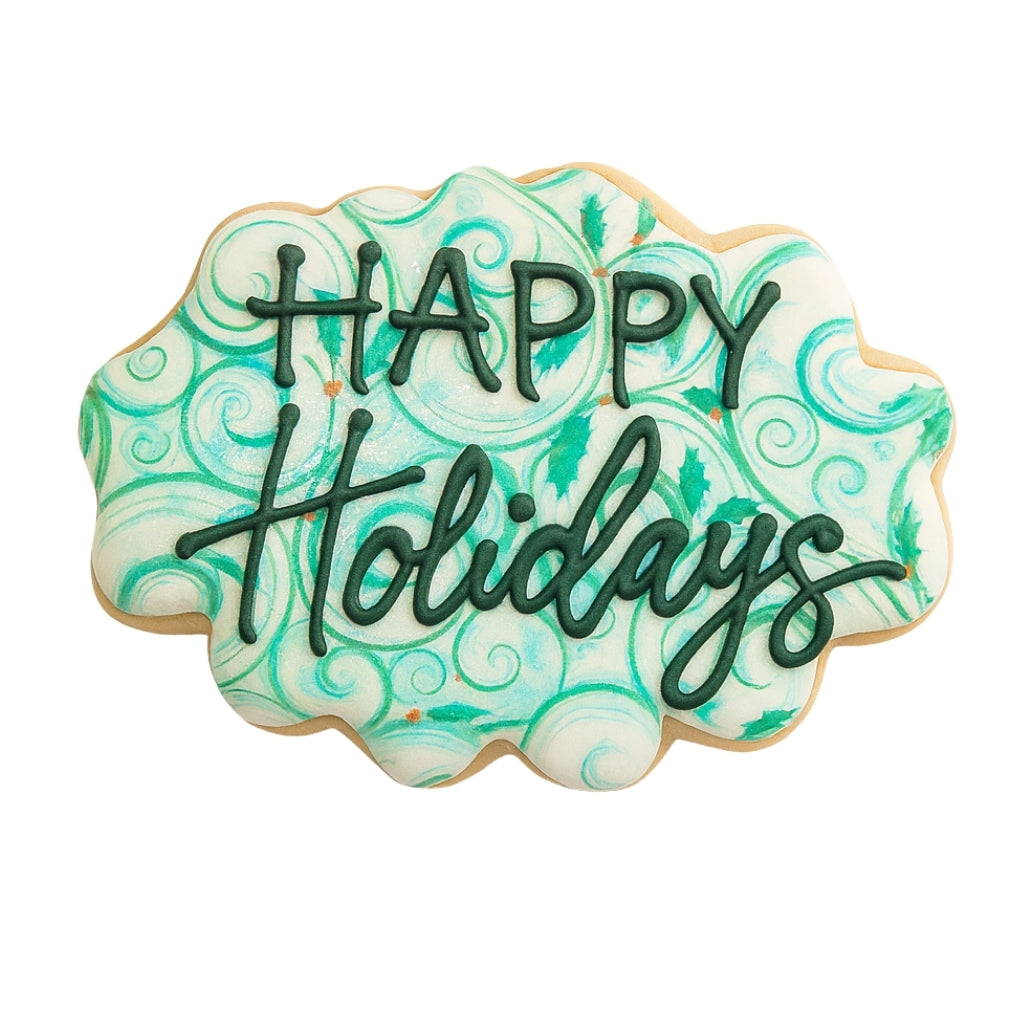 Happy Holidays cookie with teal swirl icing and dark green lettering.