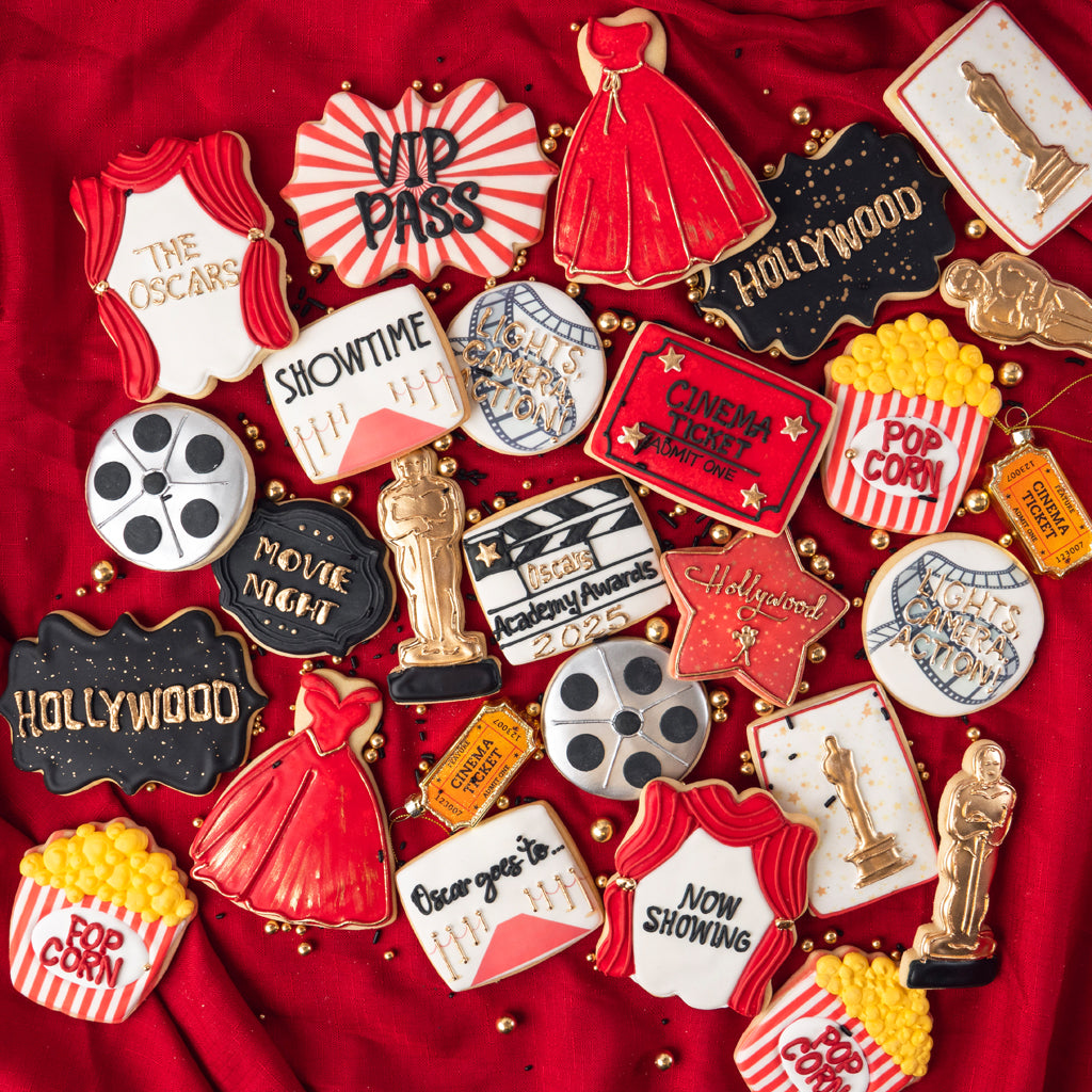 Assorted Academy Awards cookies on a red fabric background.