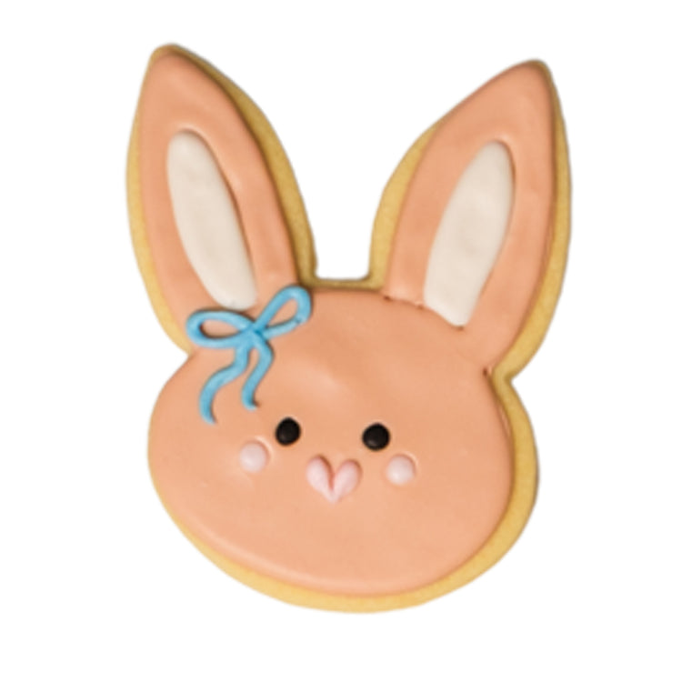 Easter butter cookie shaped like a pink bunny with a blue bow.