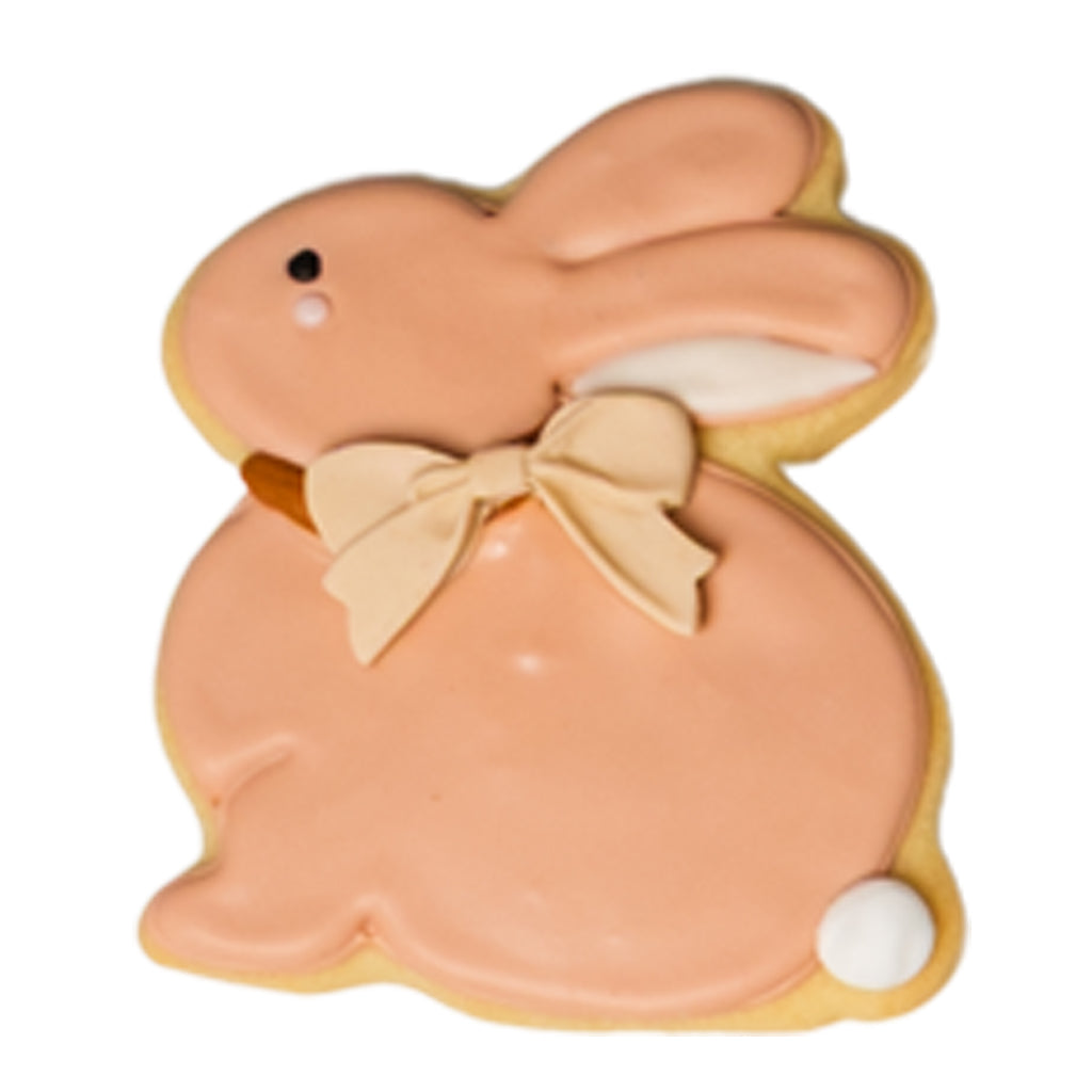 Easter butter cookie shaped like a pink bunny with a bow.