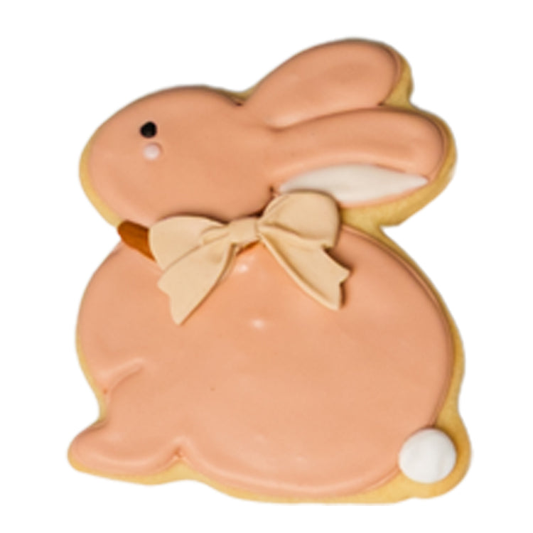 Easter butter cookie shaped like a pink bunny with a bow.