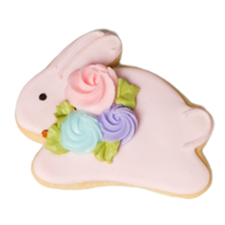 Easter butter cookie shaped like a pink bunny with floral icing.