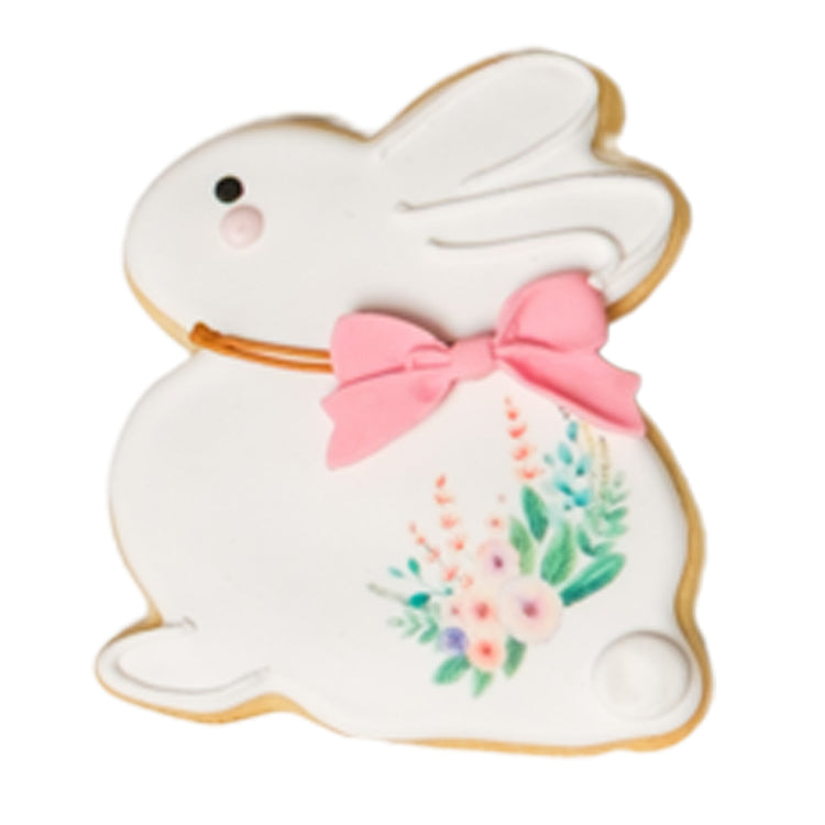 Easter butter cookie shaped like a white bunny with a pink bow.