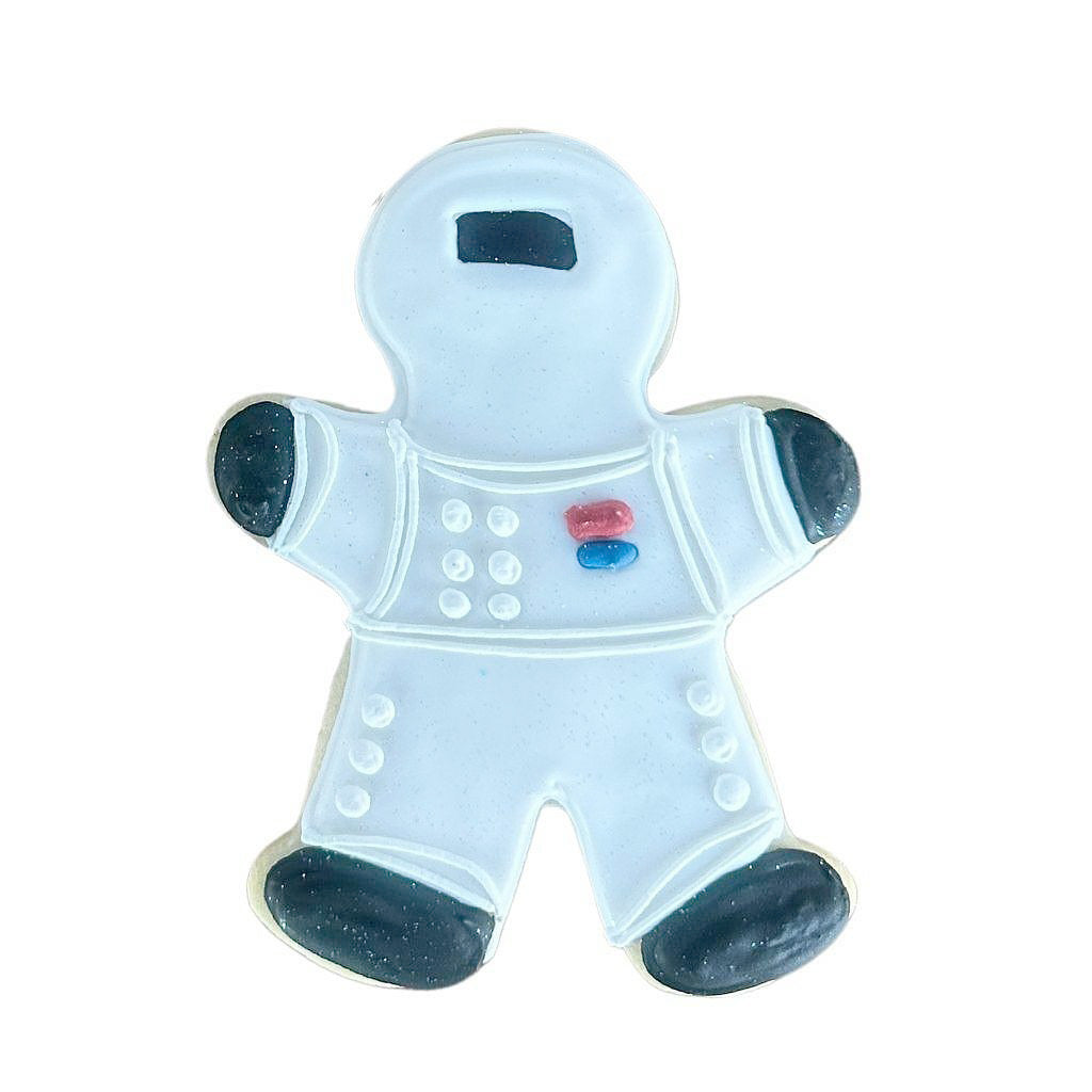 Astronaut-shaped sugar cookie with light blue icing.
