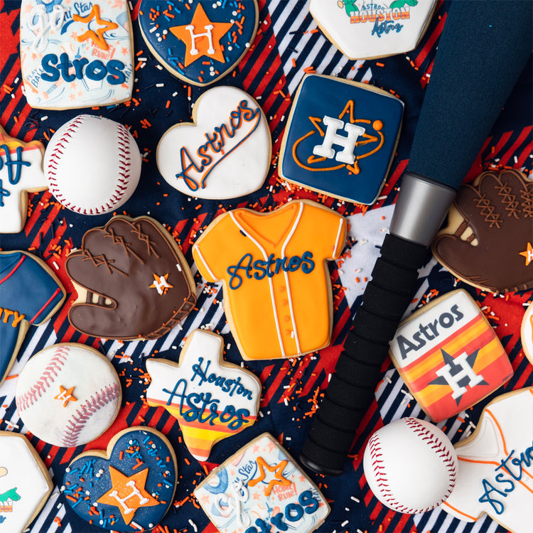 Assorted Astros cookies with baseball-themed icing designs.