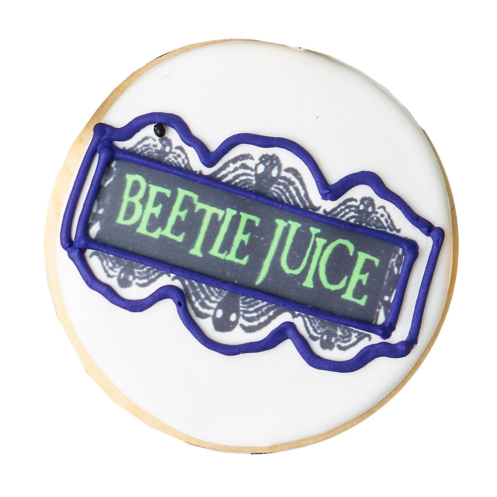 Beetlejuice butter cookie with green text and purple icing.