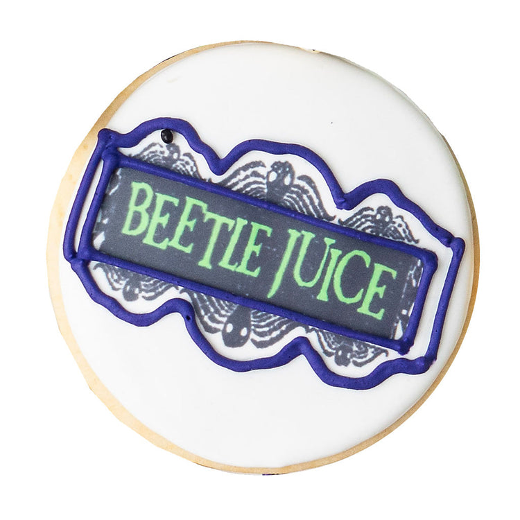 Beetlejuice butter cookie with green text and purple icing.