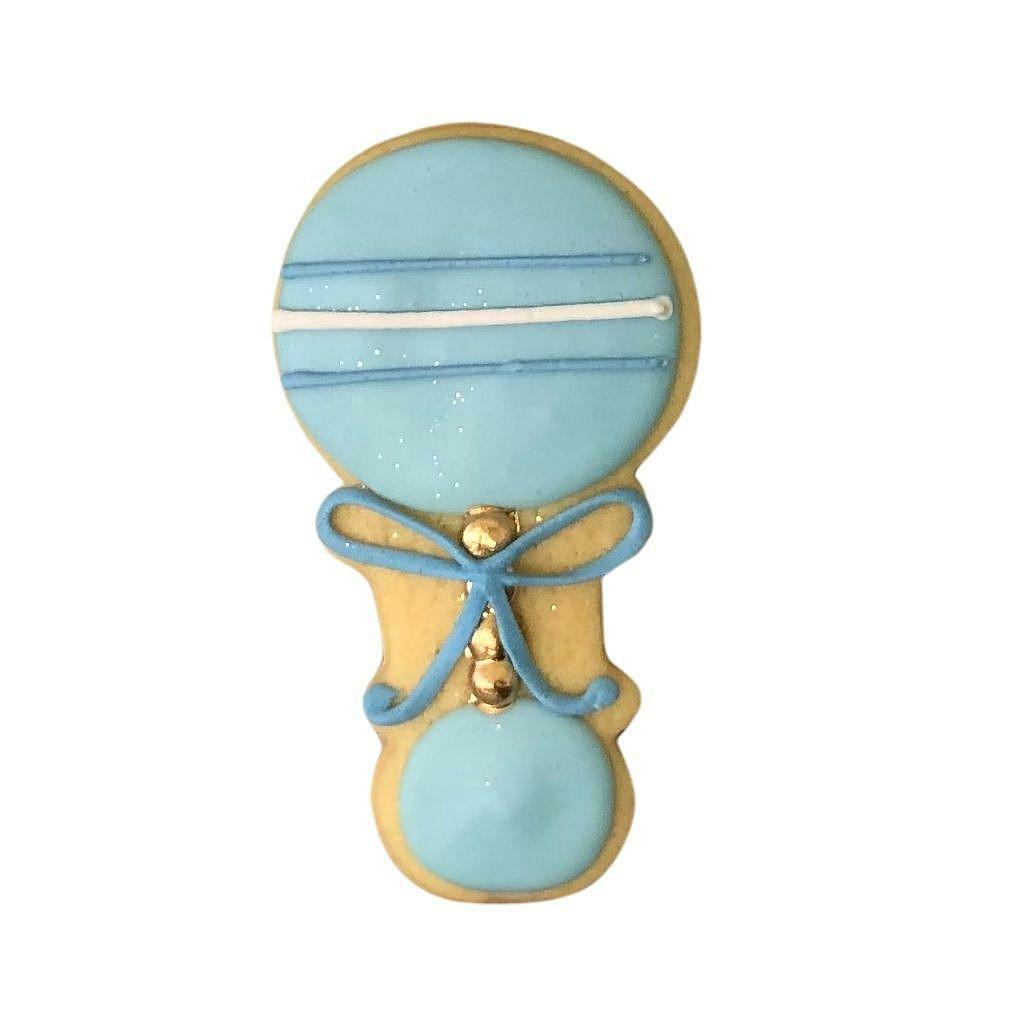 Blue Rattle #2 cookie with a blue bow and gold accents.