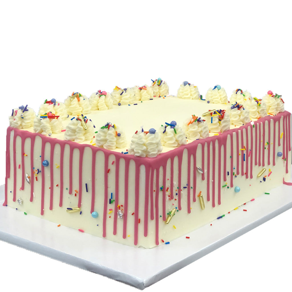 Vanilla drip cake with pink icing and colorful sprinkles.