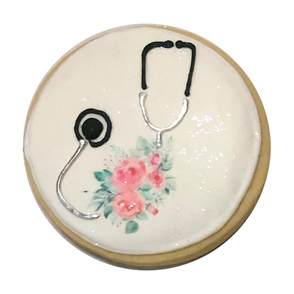 Stethoscope w/Flowers on a round white frosted cookie.